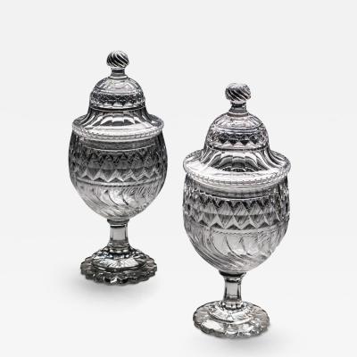 A PAIR OF GEORGE III CUT GLASS URNS COVERS OF EXCEPTIONAL SIZE QUALITY