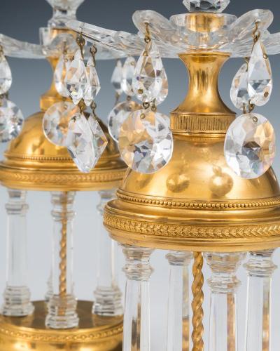 A PAIR OF GEORGE III TEMPLE CANDLESTICKS