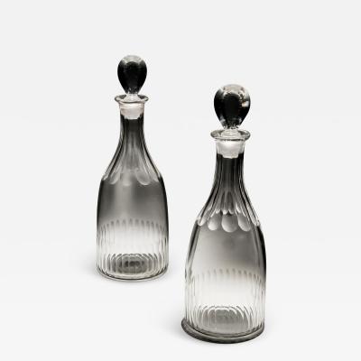 A PAIR OF GEORGIAN SLICE FLUTE SPIRIT DECANTERS