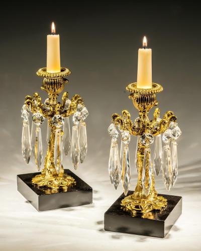 A PAIR OF GILT LACQUER DOLPHIN CANDLESTICKS