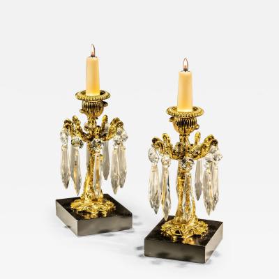 A PAIR OF GILT LACQUER DOLPHIN CANDLESTICKS