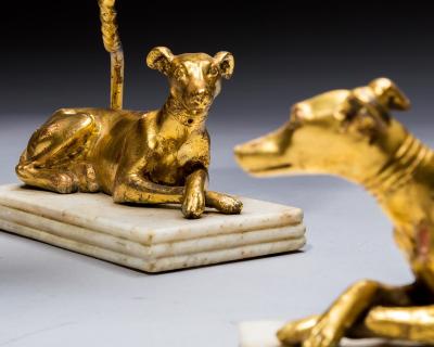 A PAIR OF GILT WOOD GREYHOUND CANDLESTICKS