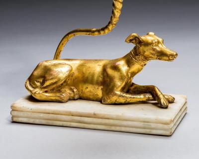 A PAIR OF GILT WOOD GREYHOUND CANDLESTICKS
