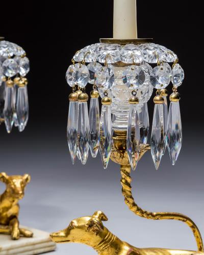 A PAIR OF GILT WOOD GREYHOUND CANDLESTICKS