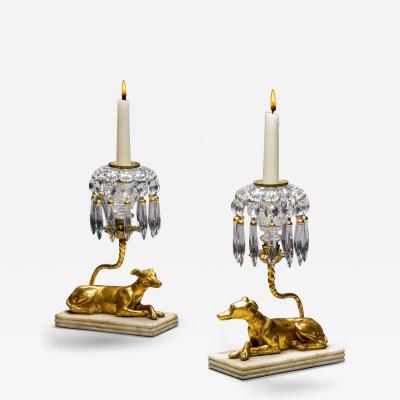 A PAIR OF GILT WOOD GREYHOUND CANDLESTICKS