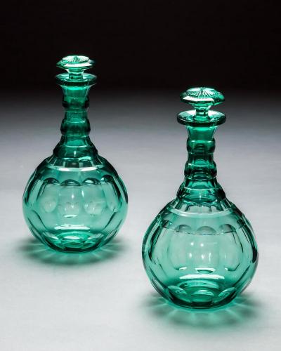 A PAIR OF GREEN SHAFT GLOBE DECANTERS