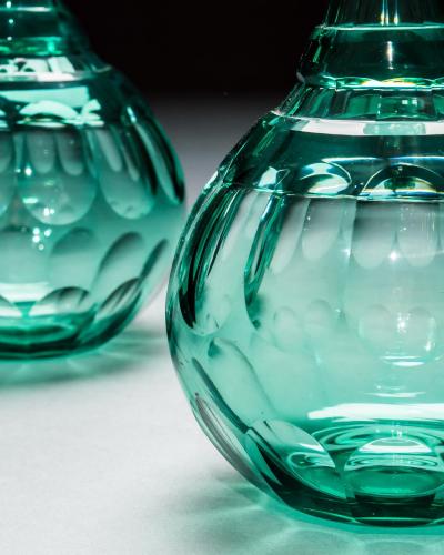 A PAIR OF GREEN SHAFT GLOBE DECANTERS