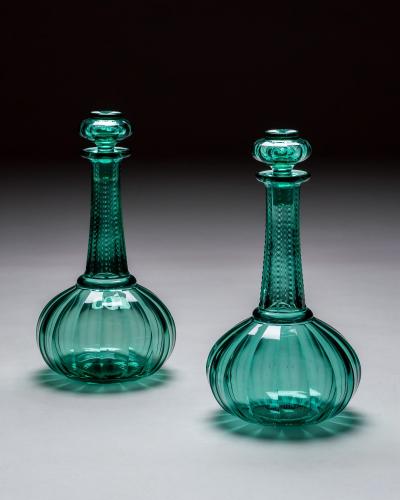 A PAIR OF GREEN SHAFT GLOBE DECANTERS