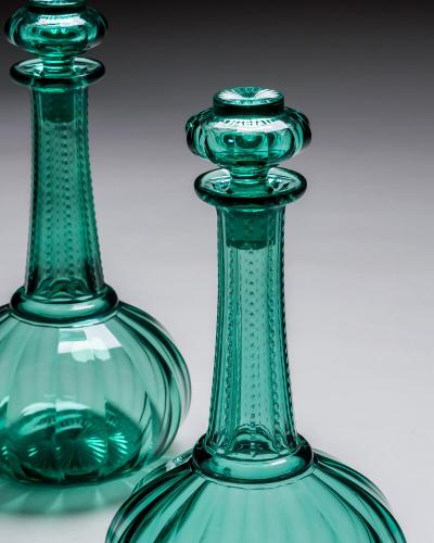 A PAIR OF GREEN SHAFT GLOBE DECANTERS