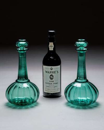 A PAIR OF GREEN SHAFT GLOBE DECANTERS