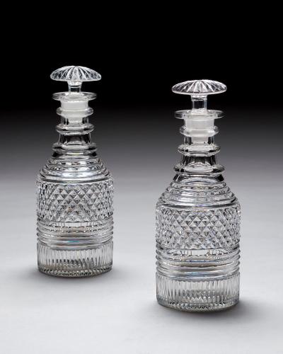 A PAIR OF HEAVILY CUT REGENCY SPIRIT DECANTERS