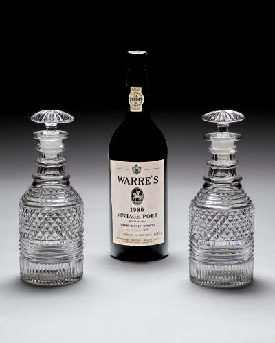 A PAIR OF HEAVILY CUT REGENCY SPIRIT DECANTERS