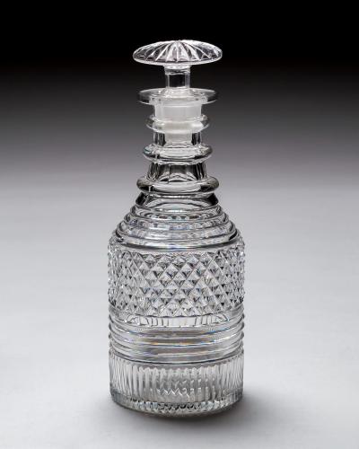 A PAIR OF HEAVILY CUT REGENCY SPIRIT DECANTERS