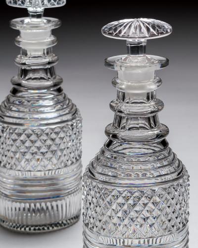 A PAIR OF HEAVILY CUT REGENCY SPIRIT DECANTERS