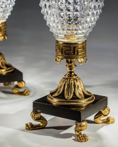 A PAIR OF REGENCY CUT GLASS STORM SHADES ON ORMOLU BRONZE BASES