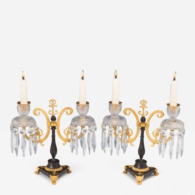 A PAIR OF REGENCY ORMOLU AND BRONZE CUT GLASS CANDELABRA