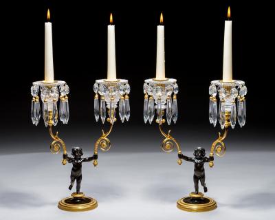 A PAIR OF REGENCY ORMOLU BRONZE BOY CANDELABRA
