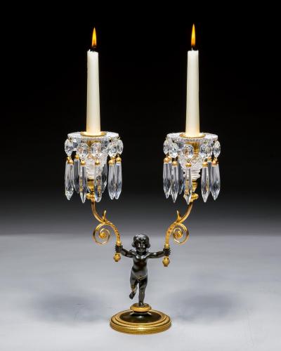 A PAIR OF REGENCY ORMOLU BRONZE BOY CANDELABRA