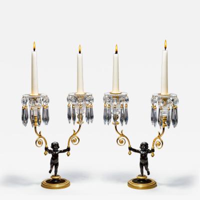 A PAIR OF REGENCY ORMOLU BRONZE BOY CANDELABRA