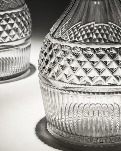 A PAIR OF REGENCY SLICE FLUTE DECANTERS WITH DIAMOND CUT BAND