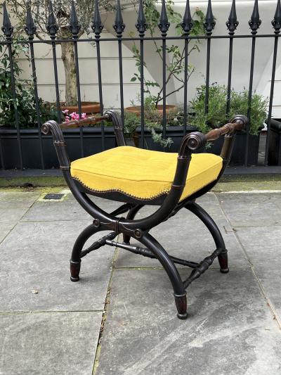A PAIR OF REGENCY X FRAMED OAK EBONISED WINDOW SEATS