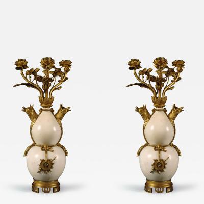 A PAIR OF STATUARY MARBLE AND GILT BRONZE MOUNTED CANDELABRA