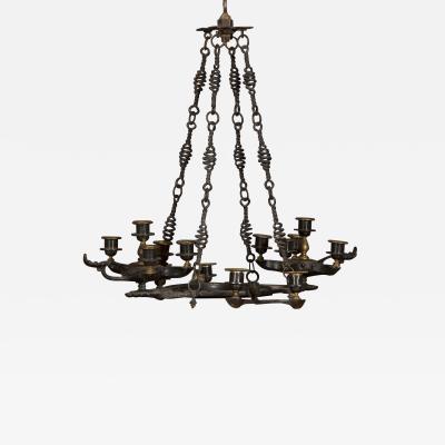 A PATINATED BRONZE FOURTEEN LIGHT CHANDELIER IN THE ANCIENT ROMAN TASTE