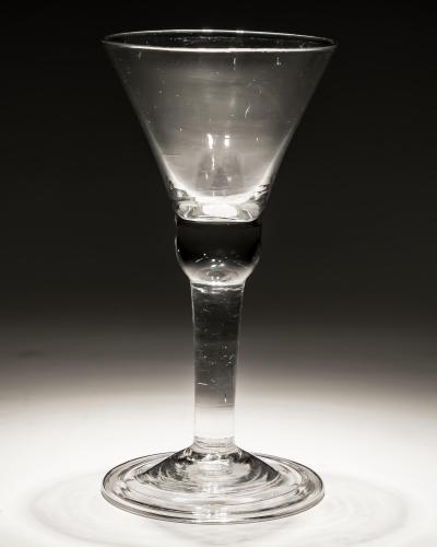 A PLAIN STEM GLASS WITH BELL BOWL FOLDED FOOT