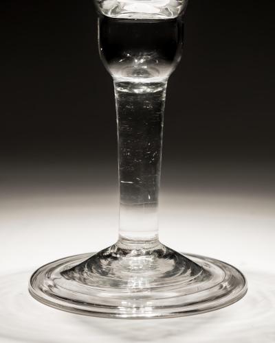 A PLAIN STEM GLASS WITH BELL BOWL FOLDED FOOT