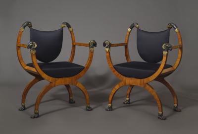 A Pair Of Neoclassical X Form Armchairs With Parcel Gilt And Bronzed Detailing