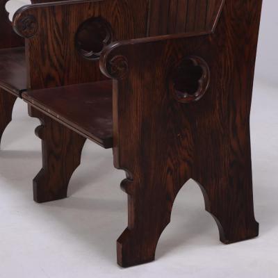 A Pair of American Gothic style carved oak double benches C 1900 