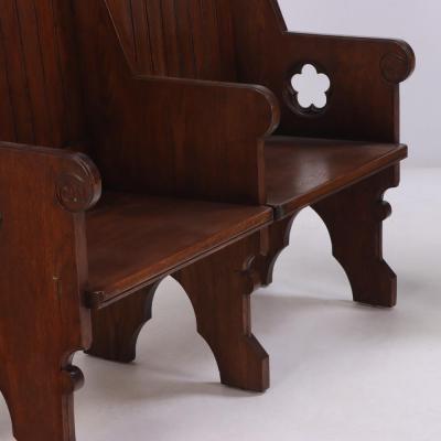 A Pair of American Gothic style carved oak double benches C 1900 