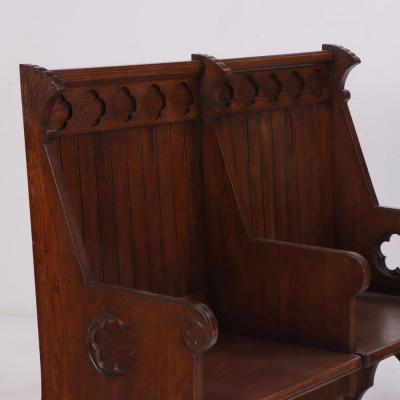 A Pair of American Gothic style carved oak double benches C 1900 