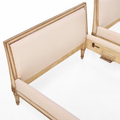A Pair of French Louis XVI style Painted and Gilt Twin Beds C 1940 
