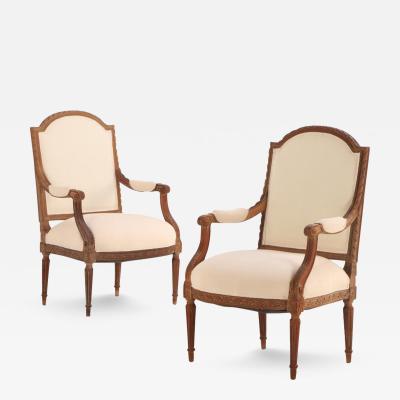 A Pair of French Louis XVI style carved open arm chairs C 1920 