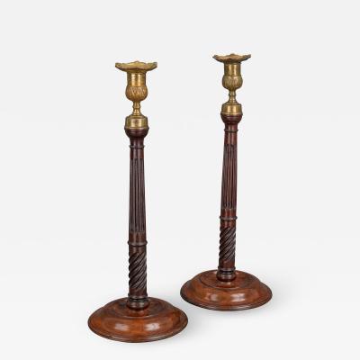 A Pair of George III Mahogany and Brass Candlesticks