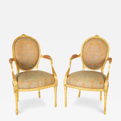 A Pair of George III Period Giltwood Oval Back Elbow Chairs