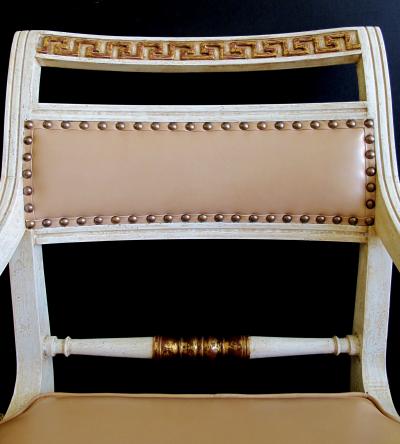 A Pair of Hollywood Regency Ivory Painted and Parcel Gilt Klismos Armchairs