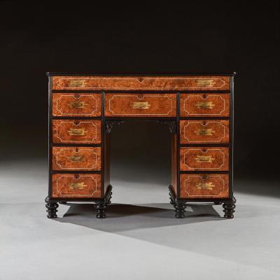 A RARE CHINESE EXPORT AMBOYNA AND EBONY CAMPAIGN KNEEHOLE DESK
