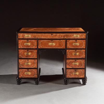 A RARE CHINESE EXPORT AMBOYNA AND EBONY CAMPAIGN KNEEHOLE DESK