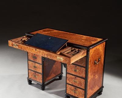 A RARE CHINESE EXPORT AMBOYNA AND EBONY CAMPAIGN KNEEHOLE DESK