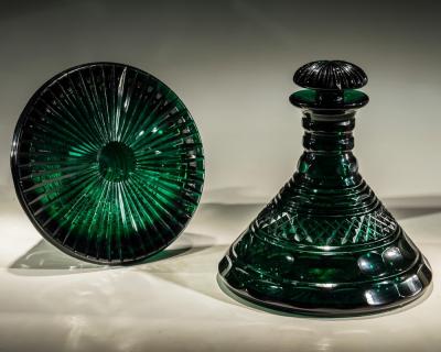 A RARE PAIR OF HEAVILY CUT EMERALD GREEN DECANTERS