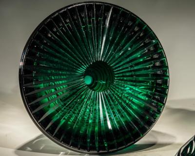 A RARE PAIR OF HEAVILY CUT EMERALD GREEN DECANTERS