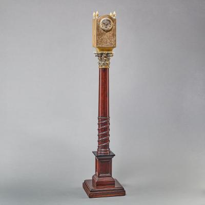 A REGENCY LANTERN CLOCK ON MAHOGANY AND EBONIZED BASE