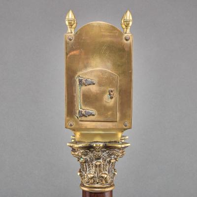 A REGENCY LANTERN CLOCK ON MAHOGANY AND EBONIZED BASE