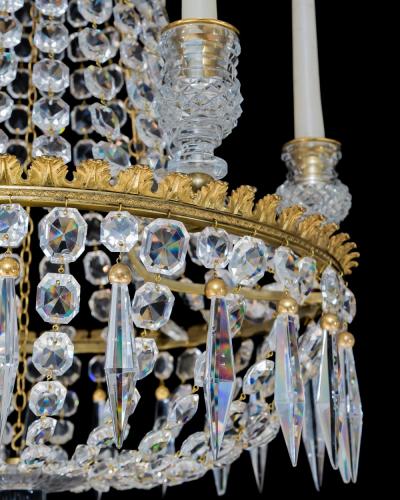 A REGENCY SIX LIGHT CRYSTAL CHANDELIER