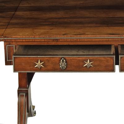 A Regency brass inlaid rosewood sofa table attributed to Gillows