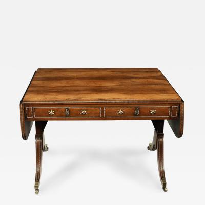 A Regency brass inlaid rosewood sofa table attributed to Gillows