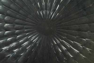 A Regency oval wall mirror cum light reflector with decorative scalloped design