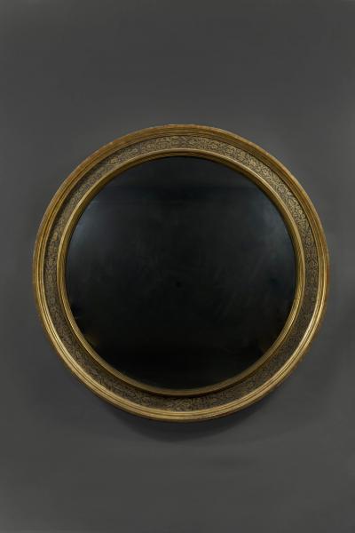 A Renaissance Revival Ebonized and Parcel Gilt Circular Convex Mirror